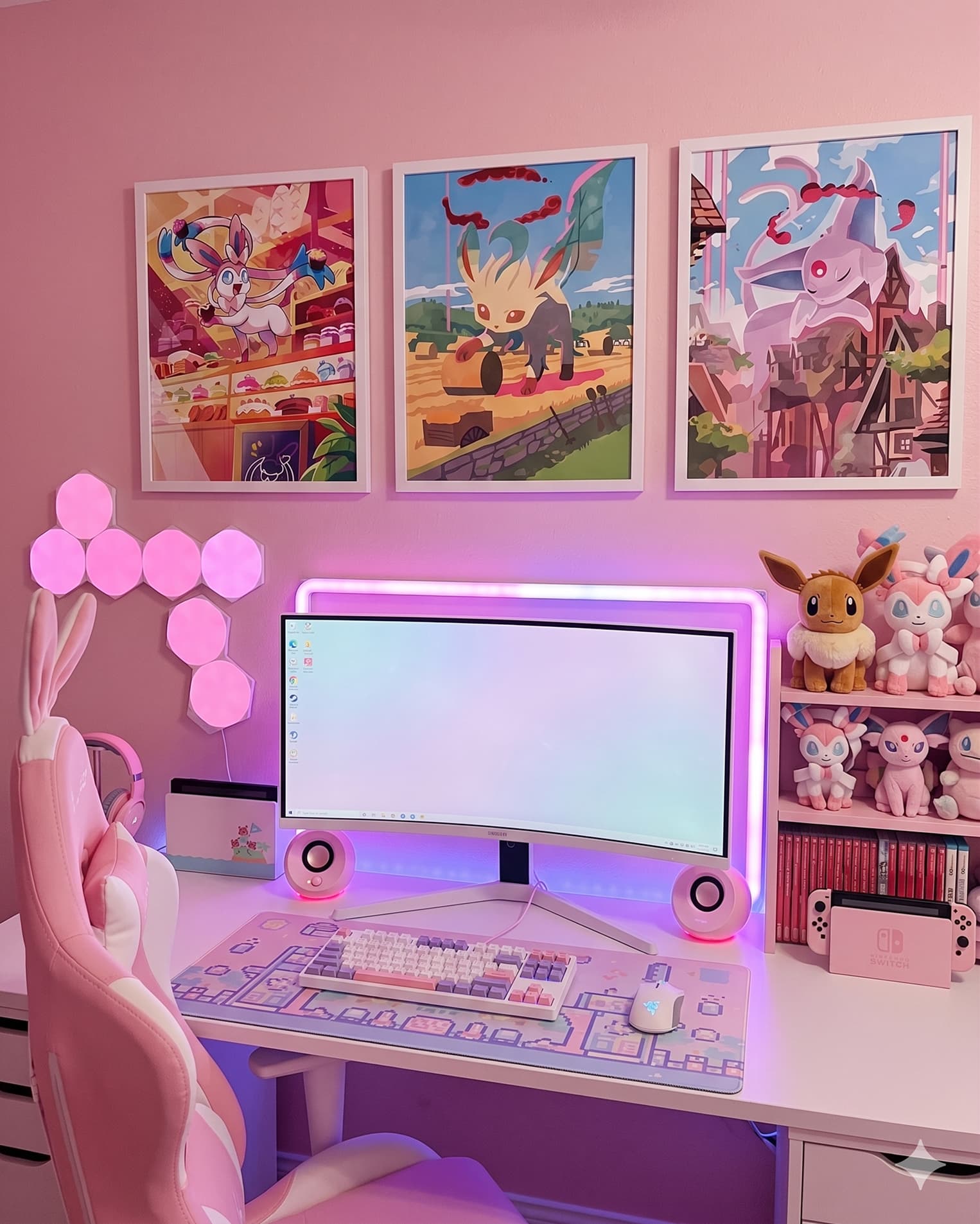 Pink Pokémon gaming setup featuring framed Sylveon, Leafeon, and Espeon art prints from Palette Town displayed above a desk with Eevee and Sylveon plushies